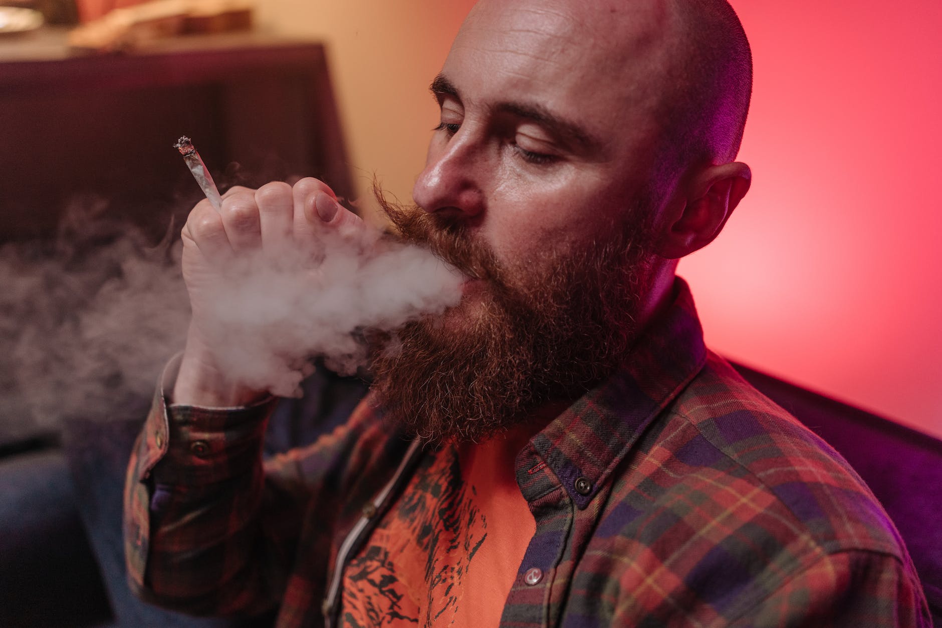 close up photo of a man smoking a joint